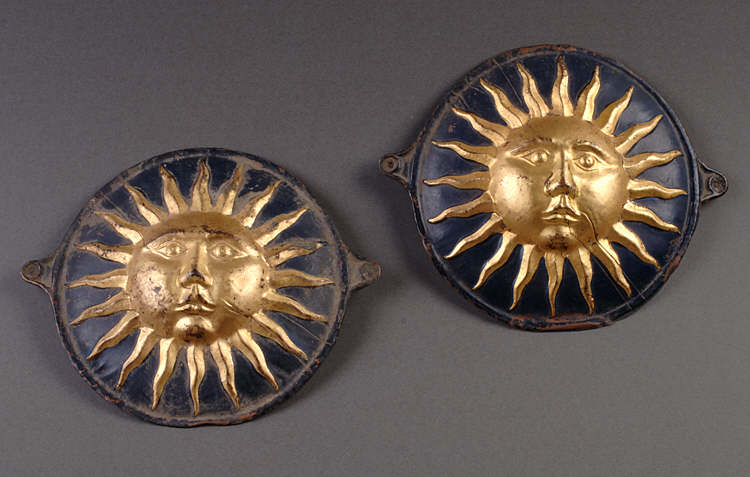 Two eighteenth-century Fire Marks, showing the gilded sun, the mark of the Sun Insurance company.