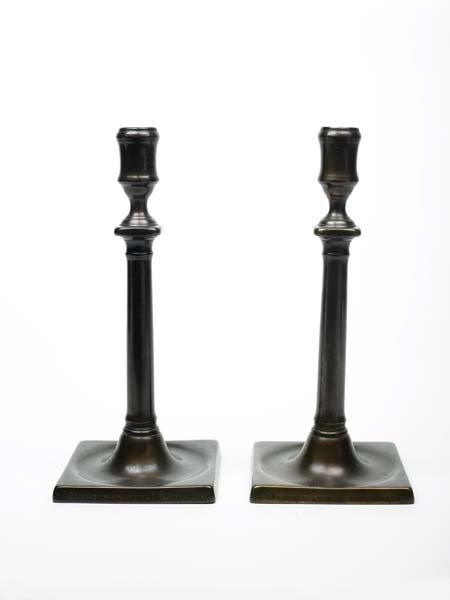 A pair of plane candlesticks from St Martin workhouse in a dark metal. Mid-eighteenth century