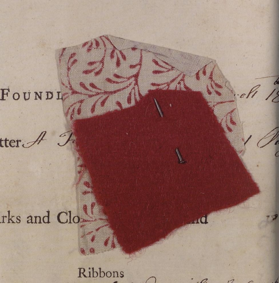 A fragment of red cloth, pinned to a piece of sprigged linen, left with a foundling child to the care of the Foundling Hospital in 1759